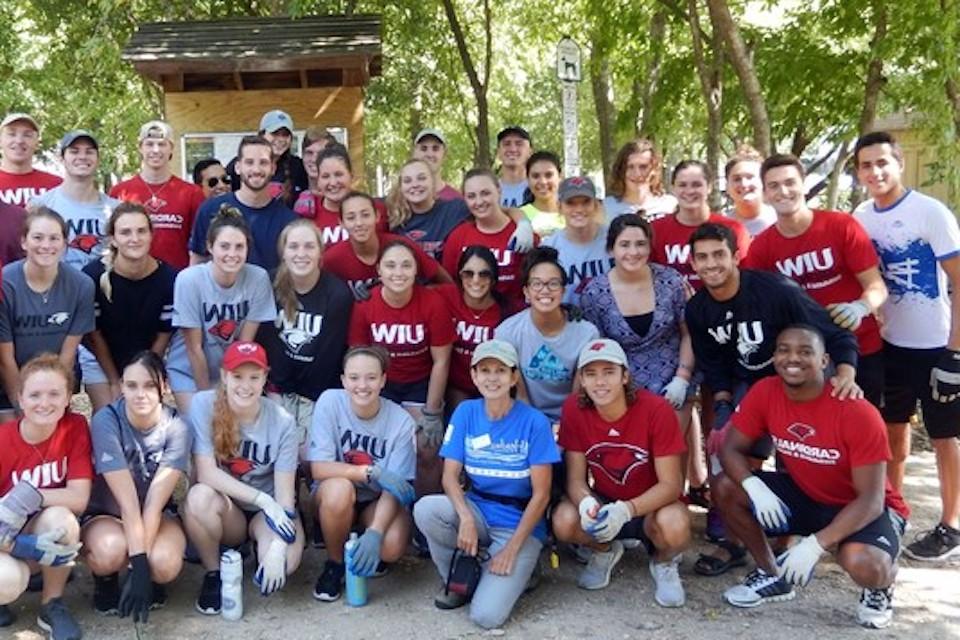 志愿者s clean the San Antonio river at UIW